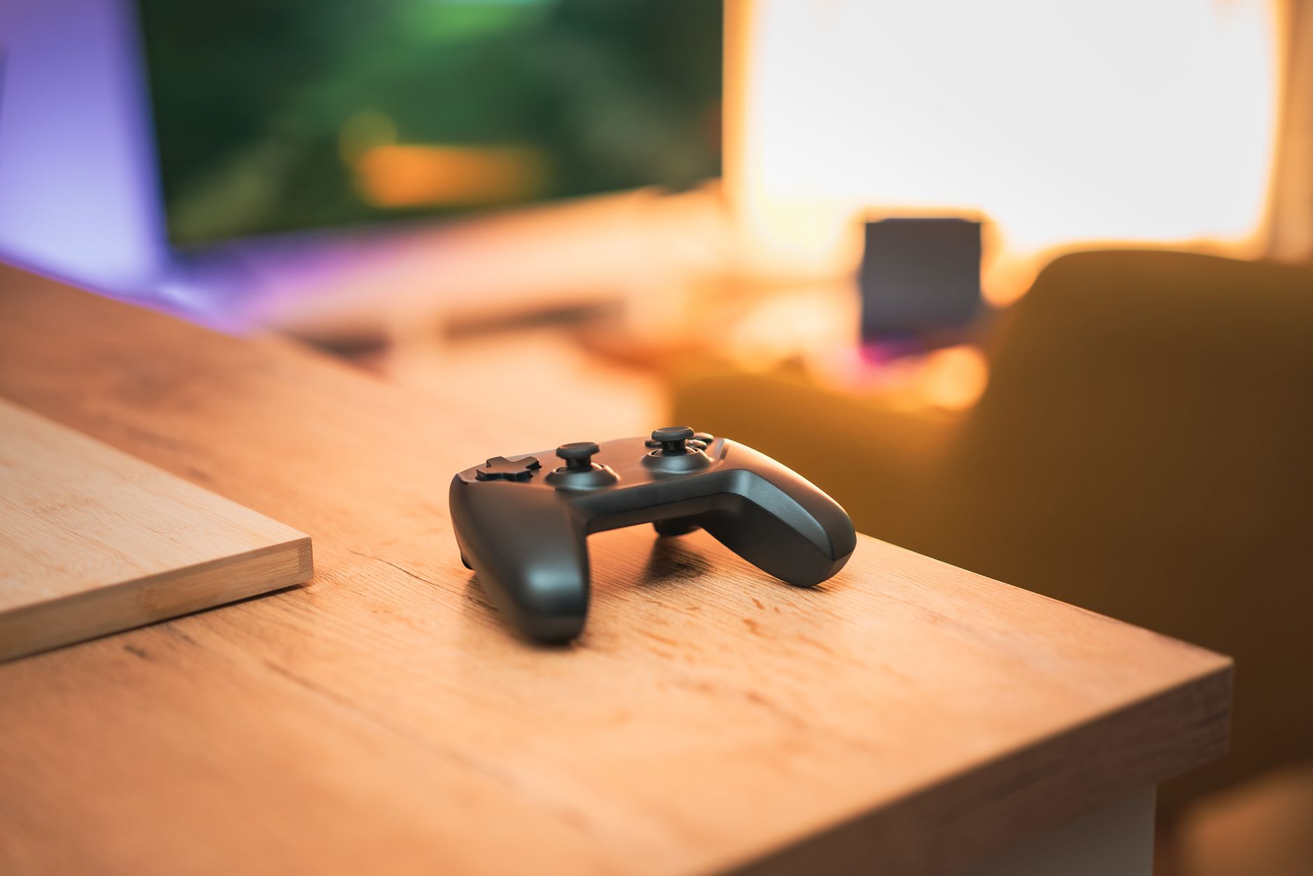 A cozy indoor scene with a video game controller on a desk, perfect for gaming enthusiasts. — Access real-time updates and hi
