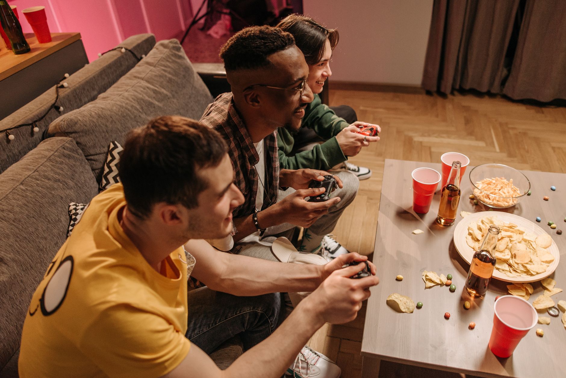 Group of friends playing video games and enjoying snacks indoors. — Access Your Account Easily Using the Ajaib88 Alternative