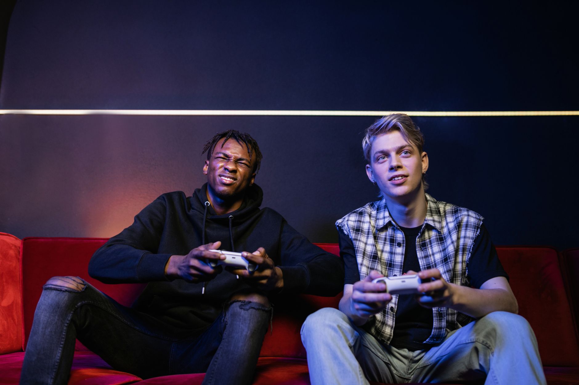 Two young men enjoying video games together on a couch, capturing leisure and friendship. — Analyzing User Engagement and Tre