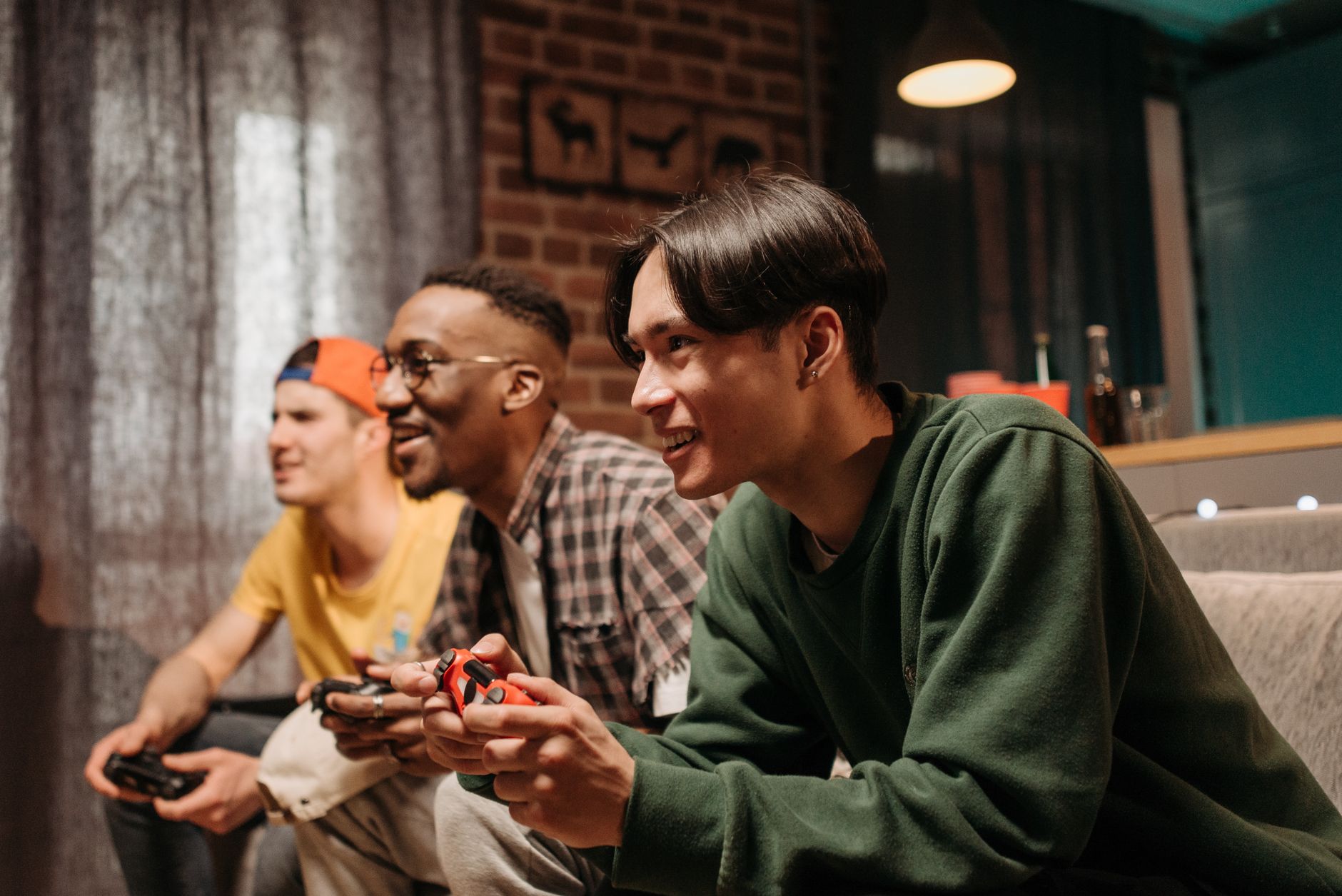 Diverse group of young adults enjoying video games together indoors, creating a fun and social atmosphere. — Best Times to Pl
