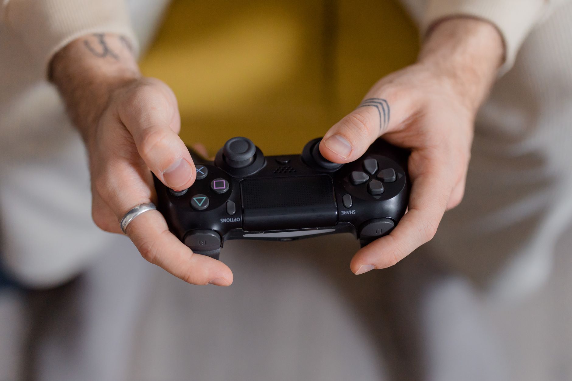 A gamer holding a black game controller, focusing on gaming and entertainment. — bplay888 Account Registration Process for Ne