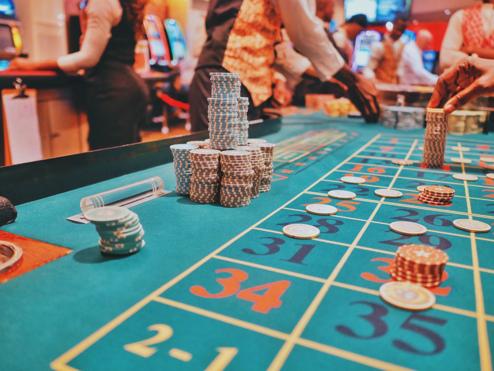 A vibrant view of a casino roulette table with poker chips and players engaged in gambling. — bplay888 Betting Interface Desi
