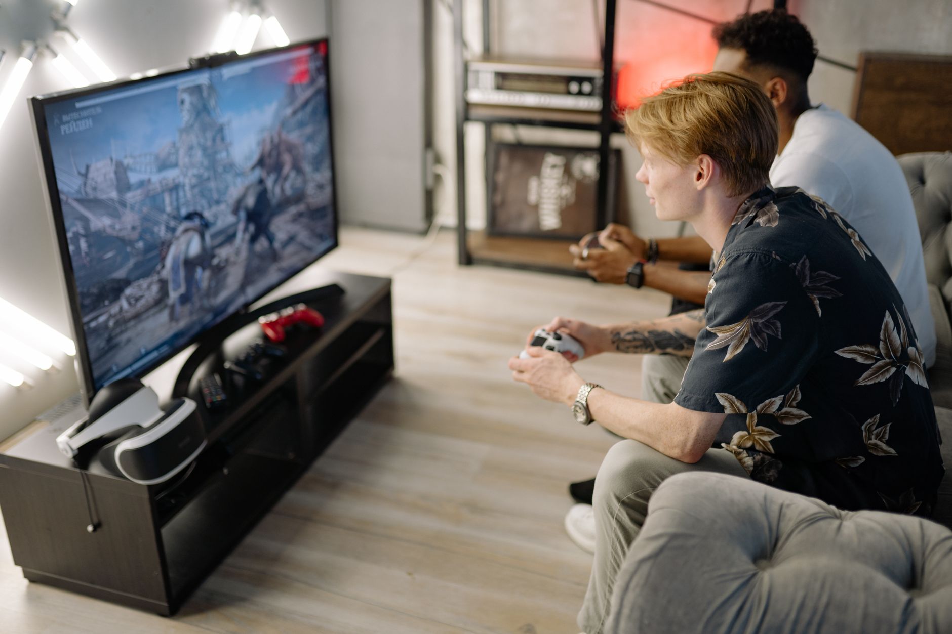 Two friends immersed in playing video games together in a cozy living room. — Experience Fast Withdrawals and Smooth Gameplay