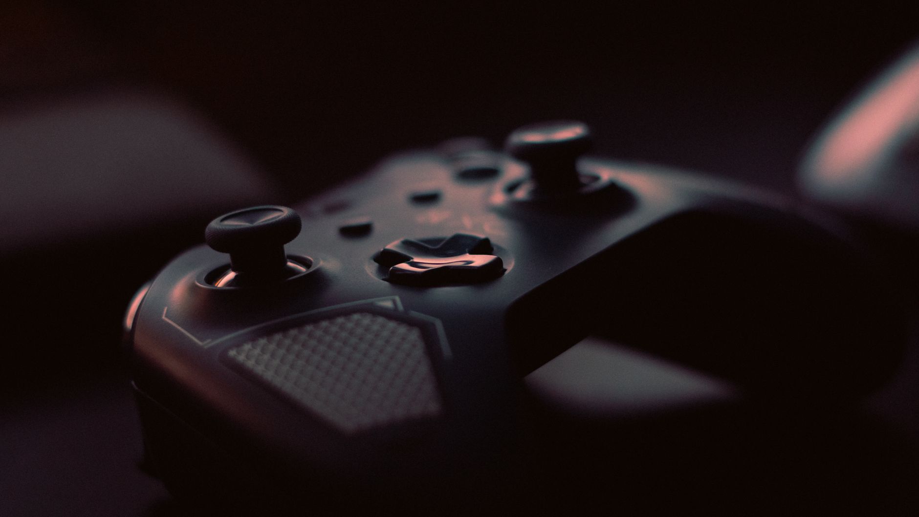 A close-up shot of a game controller in low light, highlighting its design and buttons. — Experience the Thrill of Cina777 Ga