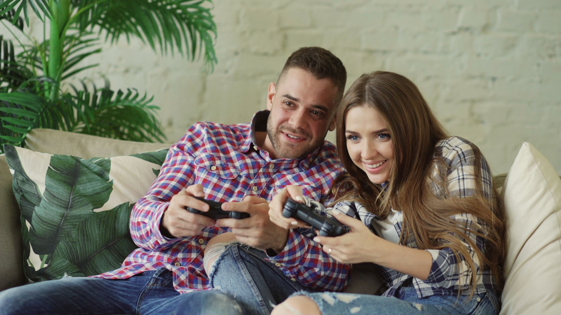 Happy couple enjoying video games together at home on a cozy sofa. — Find the Official Link to Jet234 for Seamless Access