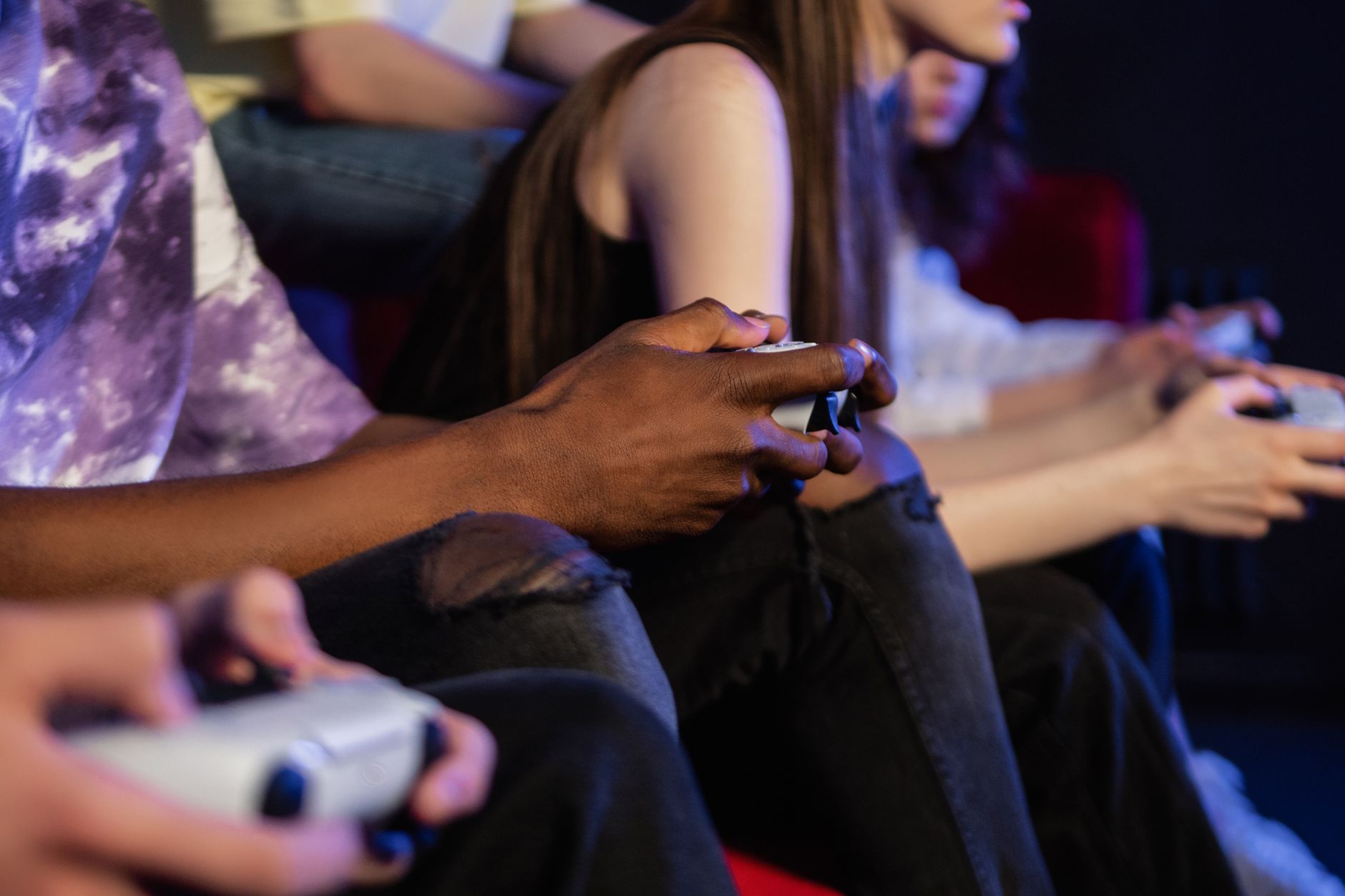 Teens playing video games with controllers, focused and engaged. — Fun88 Delivers a Smooth Betting Experience With Live Casin