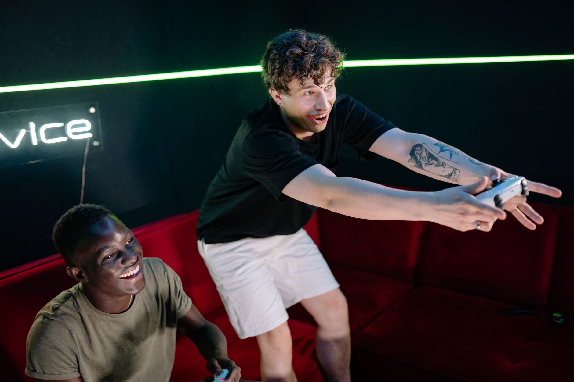 Two young men having fun playing video games in a cozy indoor setting. — How to Navigate and Play Safely on a Casino Site