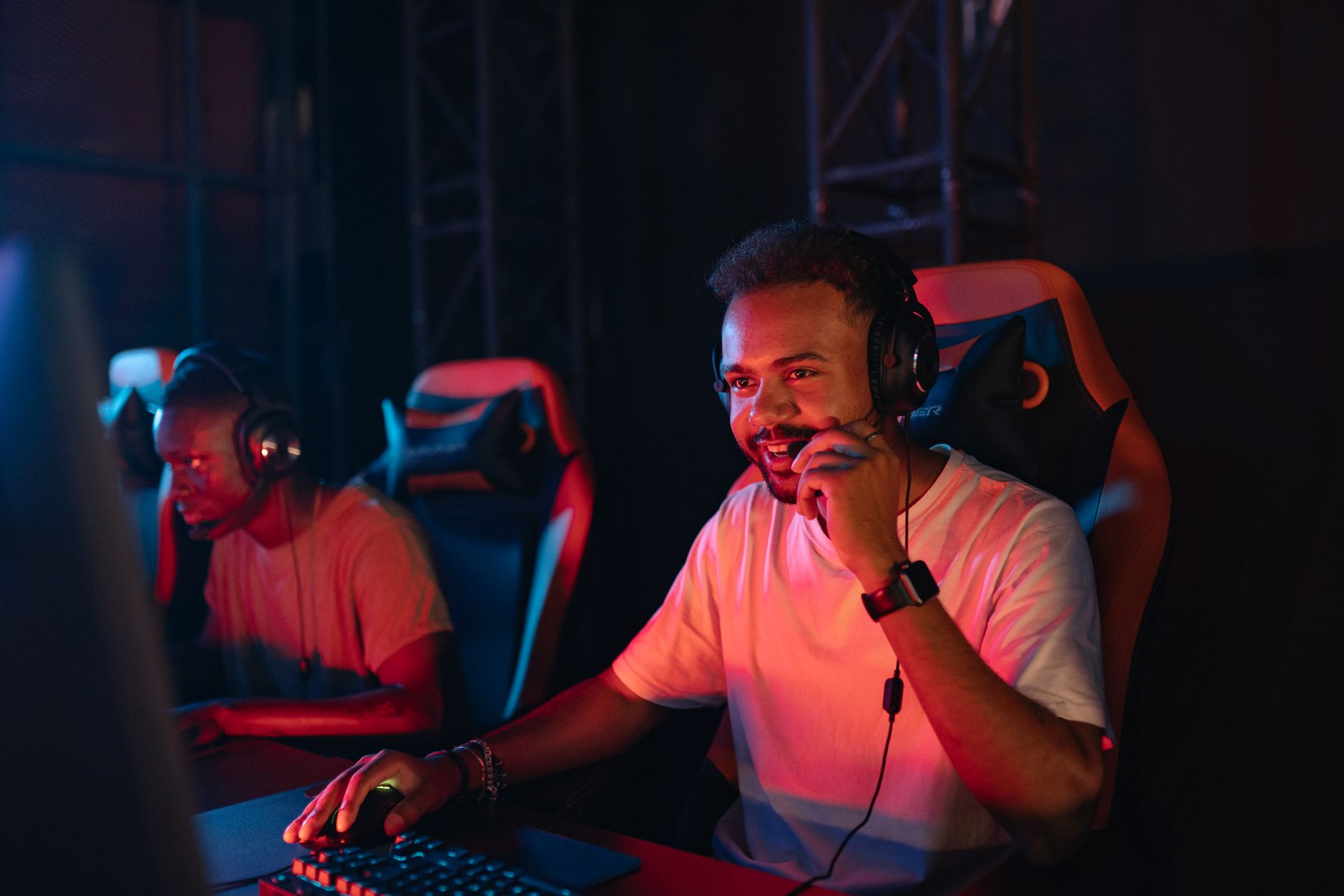 Two gamers immersed in an esports tournament, focused with headsets and keyboards. — How to Register and Play on BPLAY168 Pla