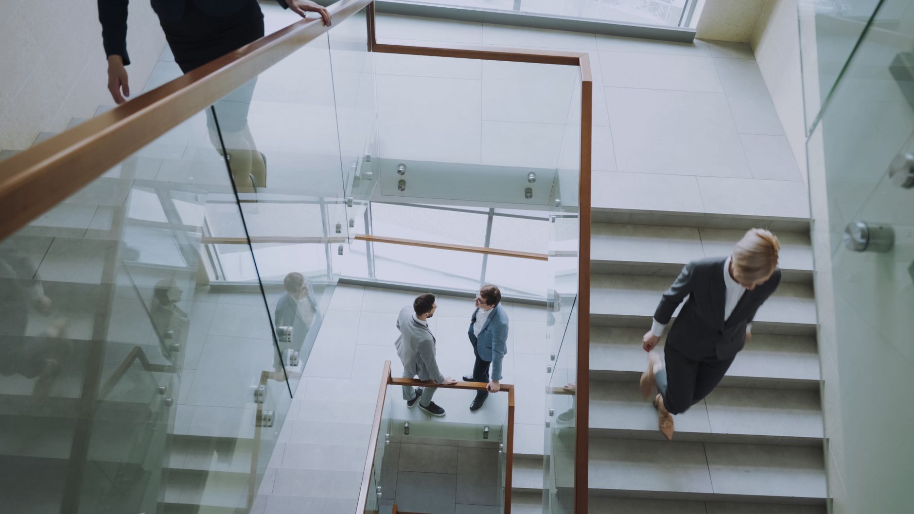 Aerial view of professionals conversing in a glass staircase in a modern office. — How U31 Slots Deliver Engaging Online Slot