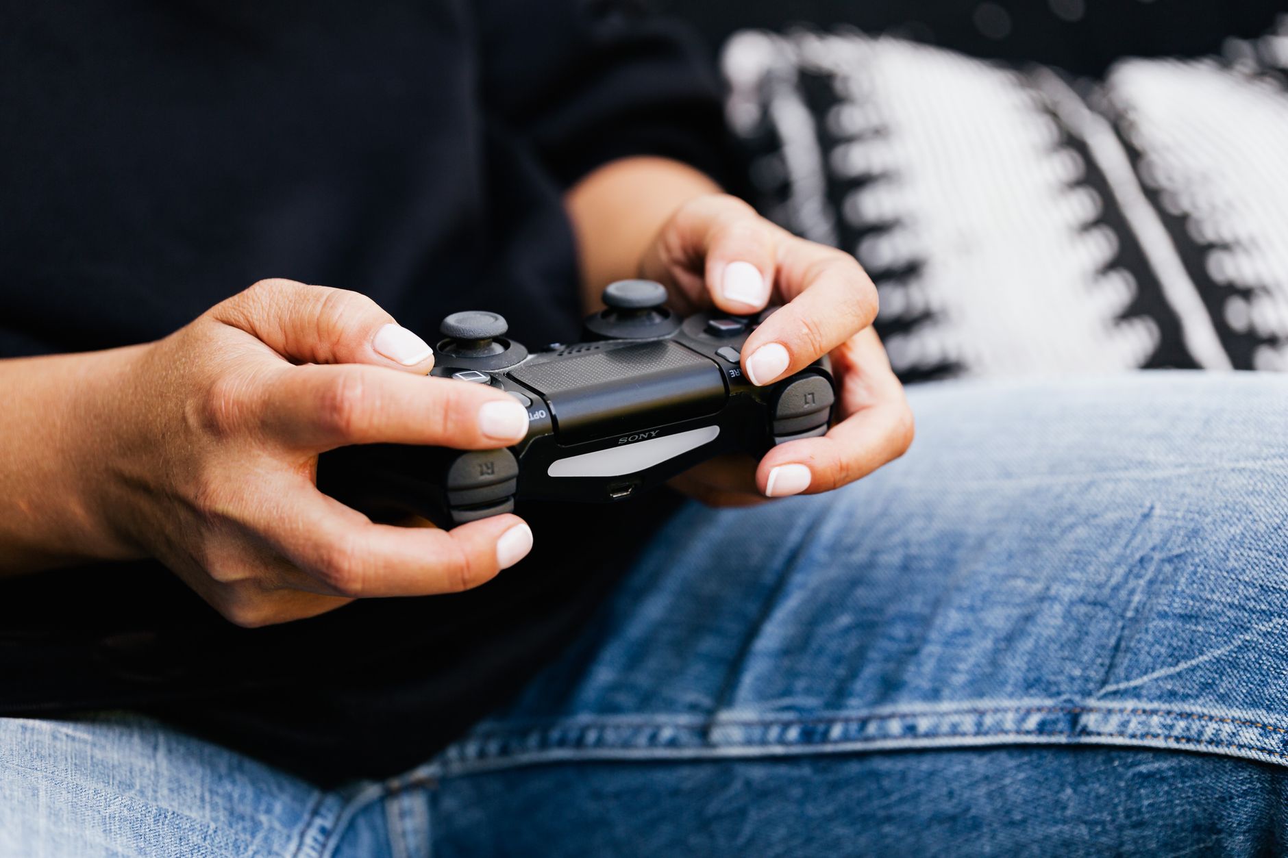 A person playing video games with a close-up of their hands holding a gaming controller. — Money Train 3 Offers Expanded Feat