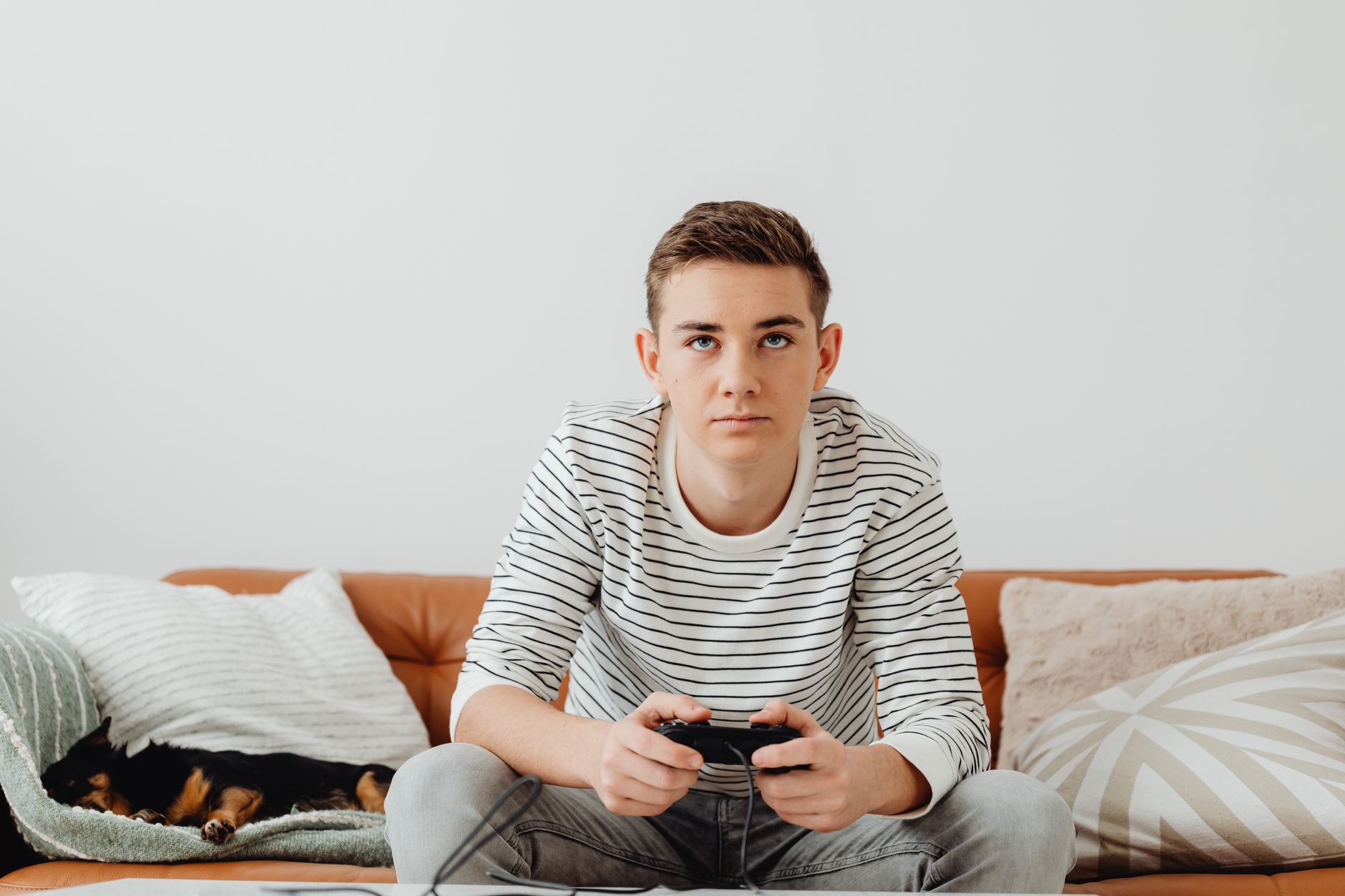 Teen boy intensely focused on video games at home, relaxing on a couch. — MPO007 Slot Login: Everything You Need to Know for