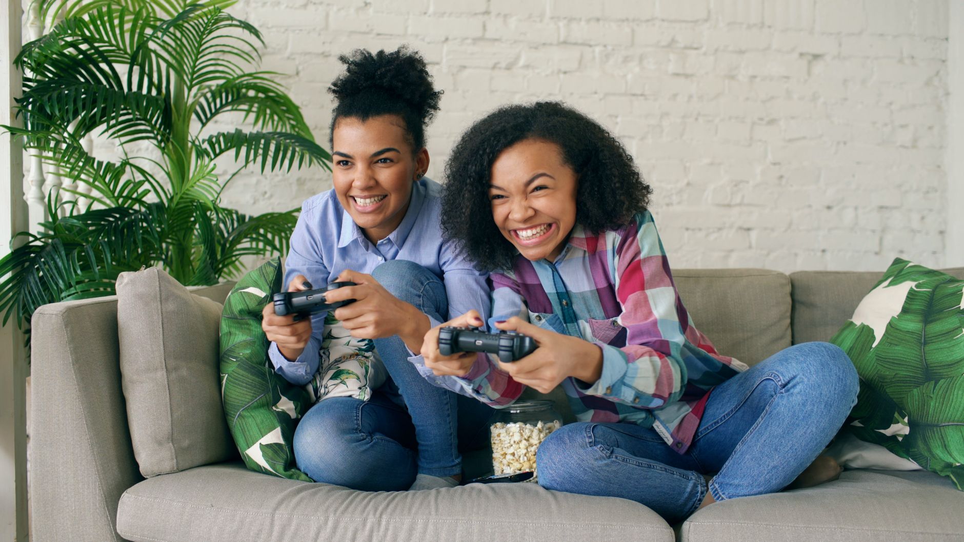 Two teenagers enjoying video games on a couch, showing excitement and joy. — MPO1221 Online Casino With User-Friendly Navigat