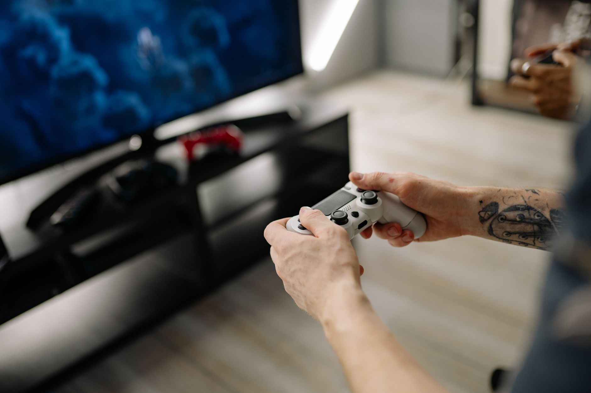 Person playing video games using a game controller indoors on a modern TV setup. — Online Slots Offering Convenient Access to