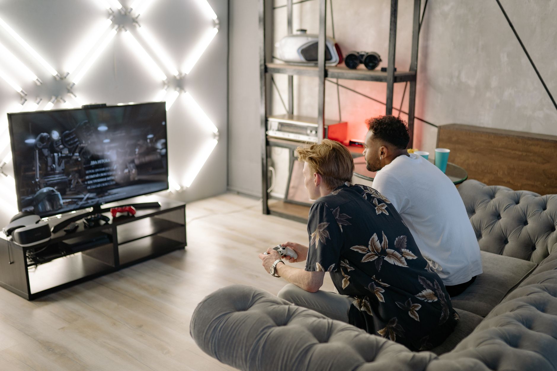 Two young men gaming together in a stylish modern living room with a large TV. — The Casino Game Advantage: How to Turn Fun i