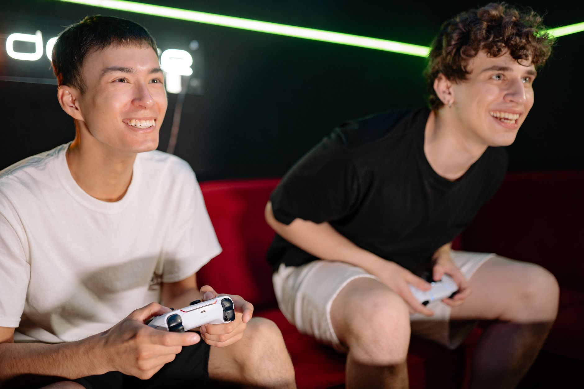Two friends having fun playing video games indoors, captured in a lively and engaging moment. — Unlock Engaging Casino Featur